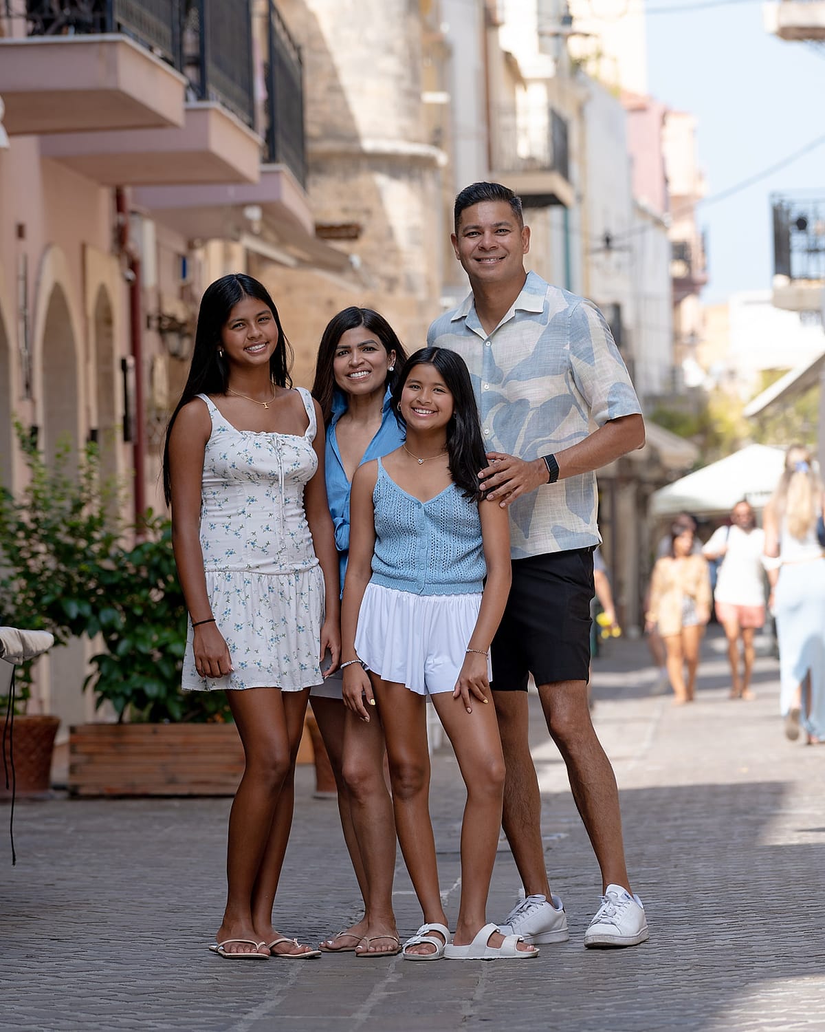 Family of four walking together on a Chania Old Town street