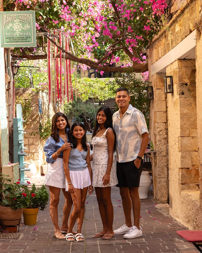 Family photographed beneath bougainvillea in a Chania Old Town alley