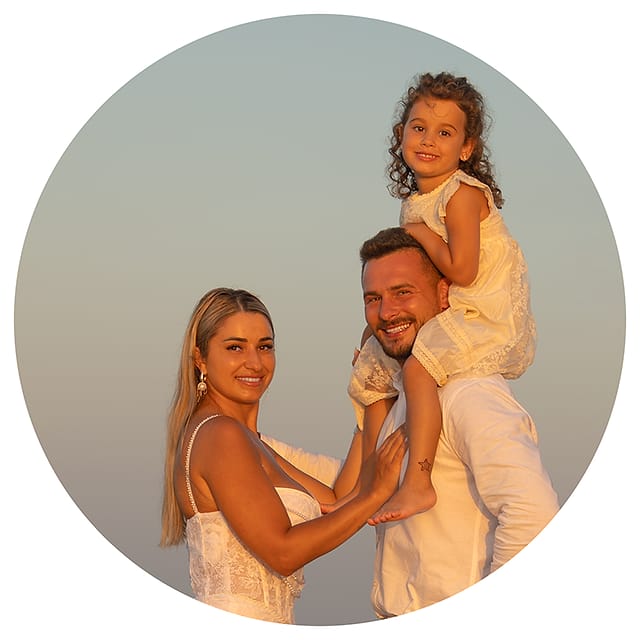 Handra Cazacu with her husband and their young daughter at sunset in Agia Marina