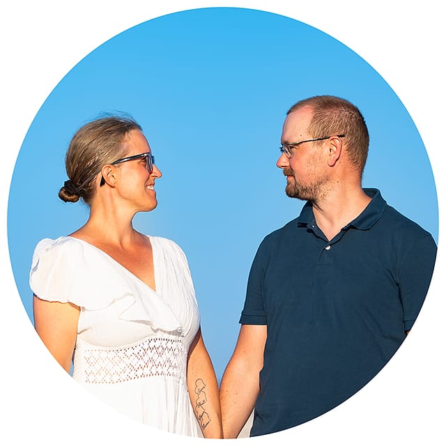 Jarkko and his partner holding hands against a clear blue sky near Chania